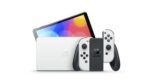 Nintendo Switch (OLED-Modell) mit Dockingstation und weißen Joy-Con-Controllern – Bild 2